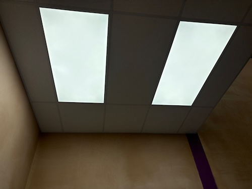 Close-up view of LED panel light installation at PackagingOne warehouse Middlewich